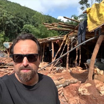 Ron Bensimon wearing sunglasses standing at an African extraction camp