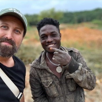 Ron Bensimon smiling alongside a local African miner at a chemical-free extraction site